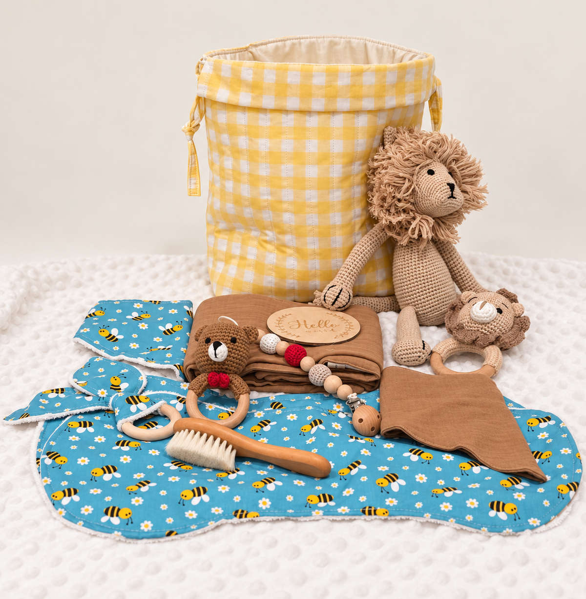 Lemon yellow Welcome Baby Hamper with bee print baby essentials and optional lion toy and lion teething ring